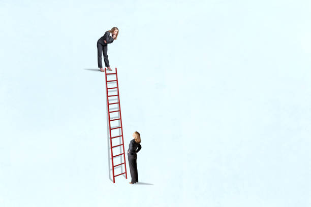 istock Two Women Looking Down And Up At A Ladder 2176177363