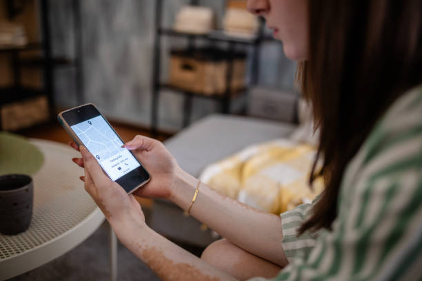 istock Woman using smartphone app seated comfortably inside. 2176179319