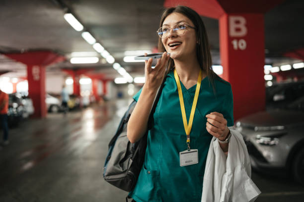istock Smiling woman records message in parking garage 2176179929