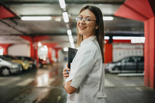 istock Professional woman smiling with clipboard in garage 2176180121
