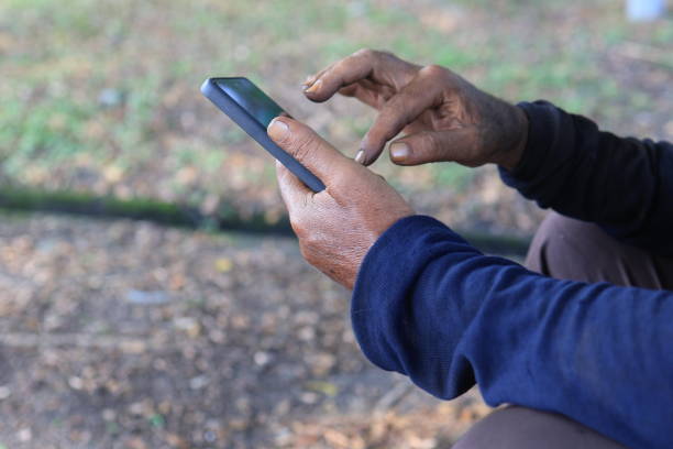 istock Close-up of hands using smartphone outdoors. 2176180551