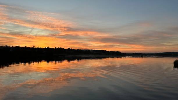 istock Bright beautiful sunset on the river, photo on a mobile phone 2176189448