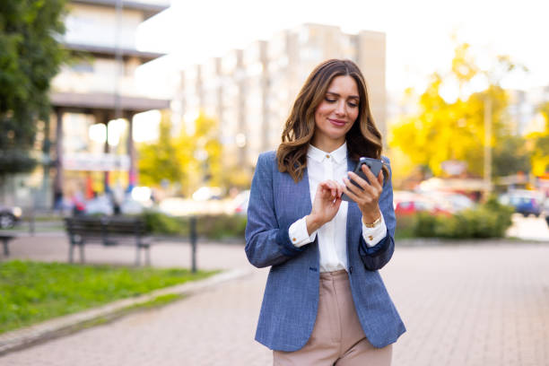 istock Middle aged woman using an app on her mobile phone 2176190349