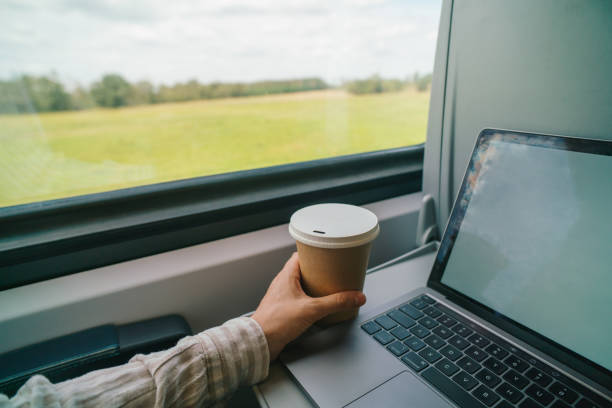 istock Morning commute with coffee and laptop on a train 2176190847