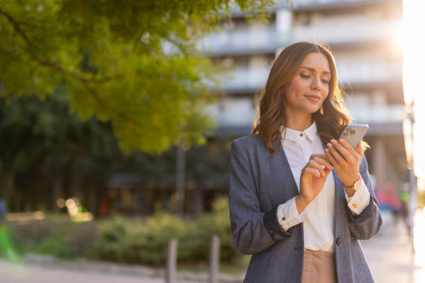 istock Middle aged woman reading a message on her smartphone 2176192887