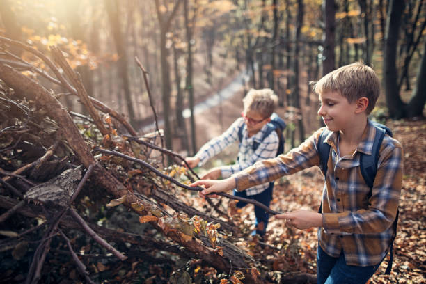 istock Little boys building a forest shelter from sticks 2176192986