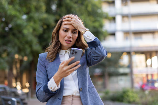 istock Middle aged woman using an app on her mobile phone 2176194639