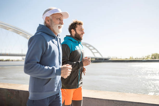 istock Father and Son Jogging by the River 2176196955