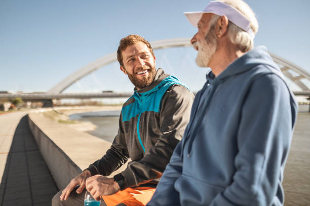 istock Father and Son Warming Up by the River 2176196991