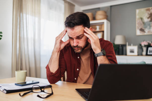istock Handsome tired businessman working late at his office 2176198817