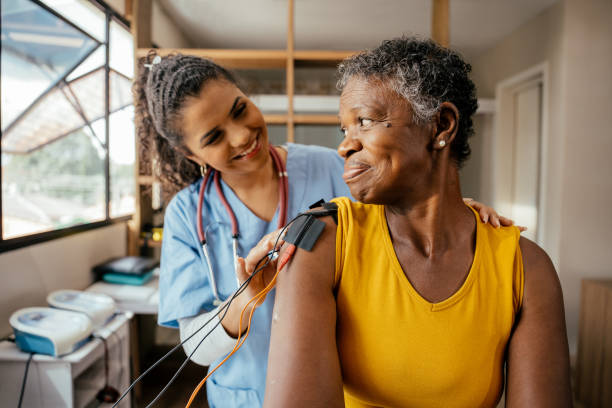istock Physiotherapist placing electrodes on elderly patient's arm 2176207974