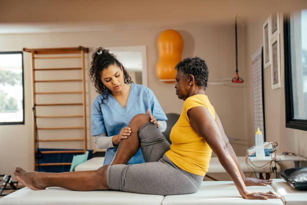 istock Physiotherapist doing rehabilitation on elderly woman's knee 2176208113