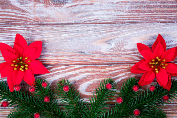 Festive composition with a Christmas tree and Christmas decorations on a wooden background. Top view. Copy space. Selective focus.