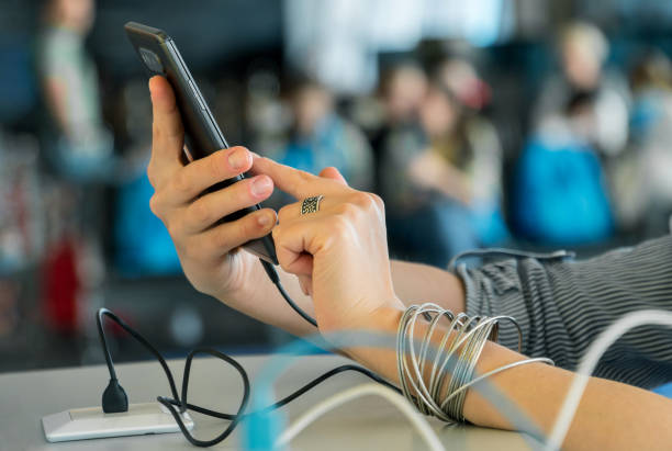 istock Close up of female hands charging smartphone using cord and usb plug in a public space while using a phone. 2176215185