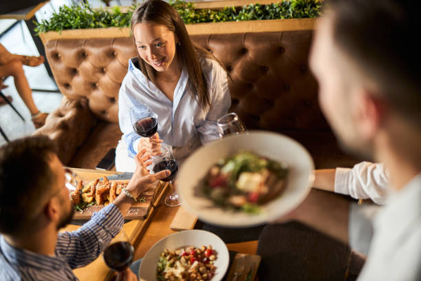 istock Happy colleagues talking while enjoying in lunch at a restaurant 2176217426