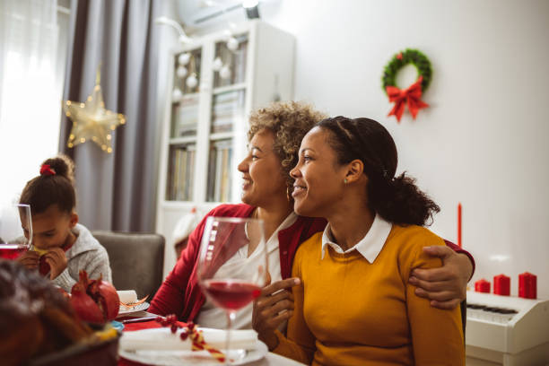 istock Mother bonding with her daughter on a Christmas Eve dinner. 2176220714