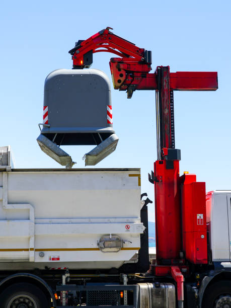 istock Modern semi-automatic emptying dustbin into waste vehicle, garbage removal, lifting mechanism 2176222912
