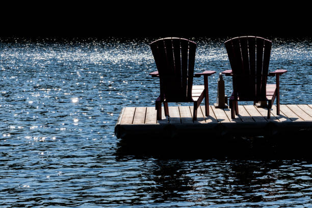 Modern buildings are mirrored in tranquil water, displaying striking colors and shapes.