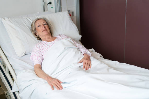 istock Mature woman resting on bed in hospital ward 2176228024