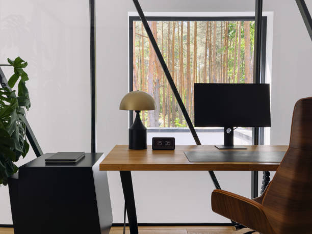 istock Modern workspace with a view of a serene forest through large windows in a stylish office 2176236280