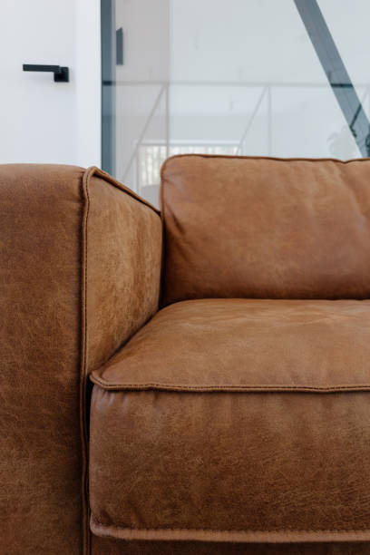 istock Cozy brown leather couch in a modern living room interior with minimalistic design 2176236925