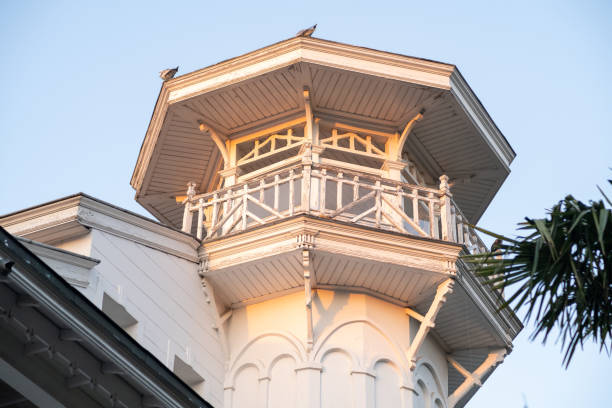 A beautifully designed tower stands tall against the evening sky, showcasing intricate architectural details in a coastal location.