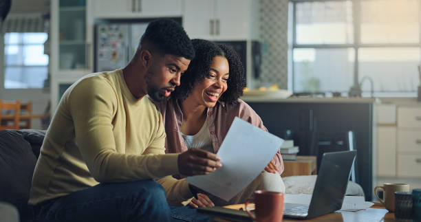 istock Positive young family do paper work paying utility bills 2176239609