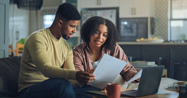 istock Positive young family do paper work paying utility bills 2176239628