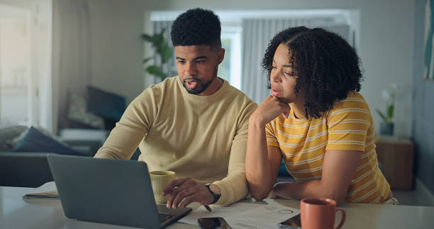 istock Positive young family do paper work paying utility bills 2176239797