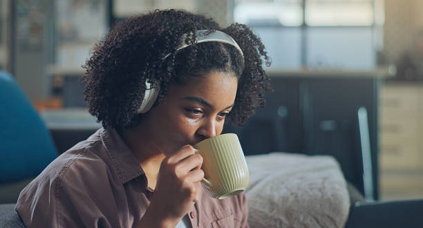 istock African American girl using laptop at home looking at screen typing chatting reading writing email. 2176240518