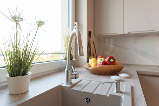 istock Kitchen sink with water tap in the kitchen with modern design and dining countertop. New apartment and real estate. 2176241011