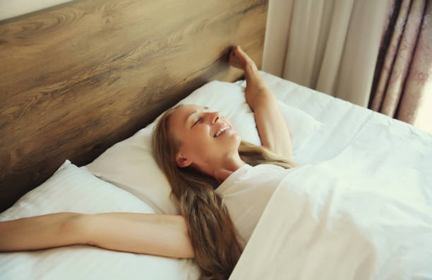 istock Woman sleeping lying in bed on white soft comfortable pillow in bedroom at home 2176246100