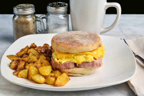 spam, scramble egg and  cheese on a english  muffin  served with home fries and coffee