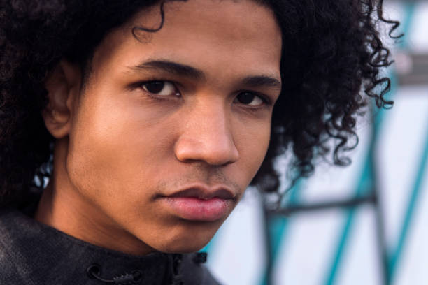 istock curly haired black male teenager looking at camera 2176267741