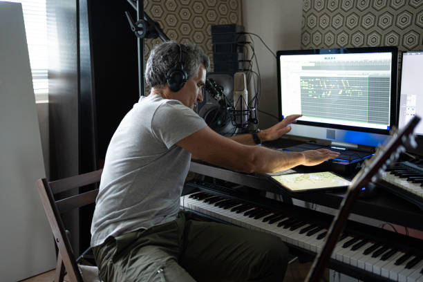 istock Musician Recording Drums on MIDI Drum Machine in Music Studio 2176268188