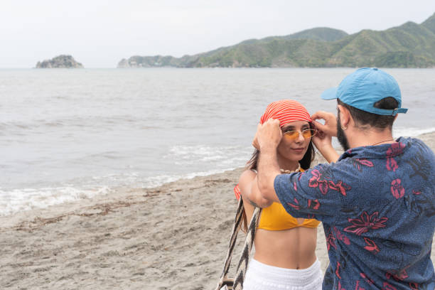Couple Enjoying a Beach Day with Stylish Headscarf