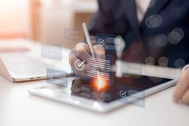 istock Businessmen work on tablet checklist questionnaire assessment forms, online surveys online exams, and Choosing the right answer in the exam. checklist and clipboard task documentation management, 2176286080