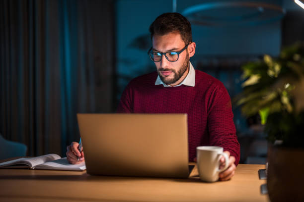 istock Hispanic Male Professional Working Late at Office Desk 2176286196