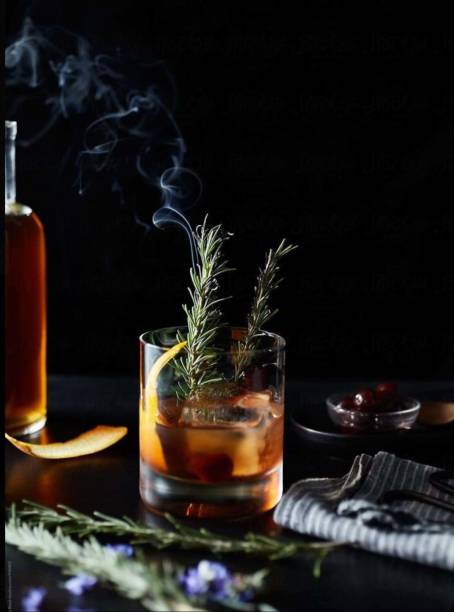 istock Old fashioned cocktail with orange and cherry on wooden table. Copyspace 2176298667