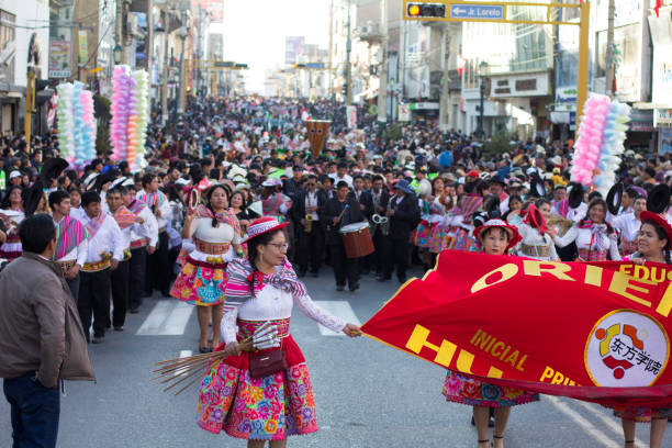 Photo of folk dancers dancing the traditional dance “Santiago” in the city of Huancayo, Peru.