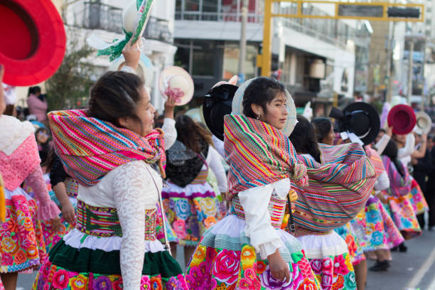 Photo of folk dancers dancing the traditional dance “Santiago” in the city of Huancayo, Peru.