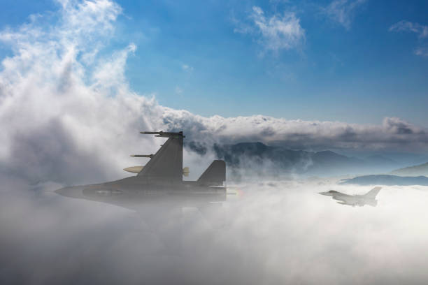 istock F-16 jet aircraft flying over clouds. 2176311509
