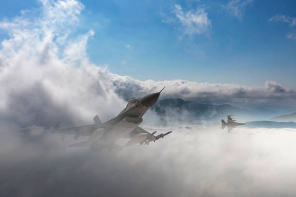 istock F-16 jet aircraft flying over clouds. 2176311528