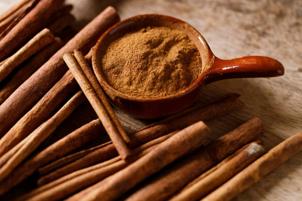istock Aromatic cinnamon sticks and powder on wooden table. 2176313226