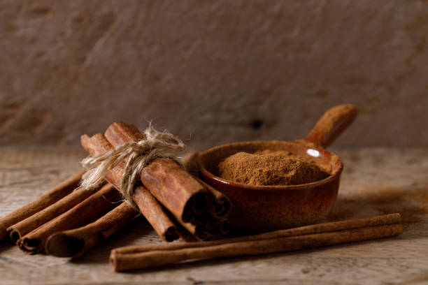 istock Aromatic cinnamon sticks and powder on wooden table. 2176313234