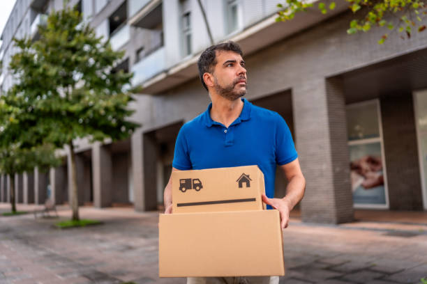 istock Mature courier delivering parcels and boxes along the city 2176315935