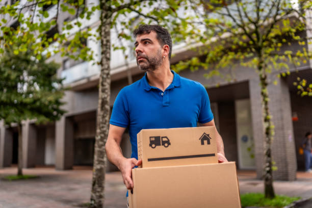istock Confident delivery man with package on street 2176315950
