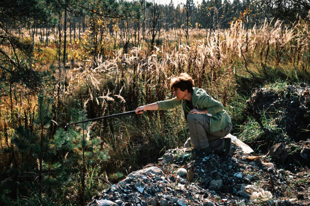 istock Woman is filming marsh landscape using action camera 2176323428