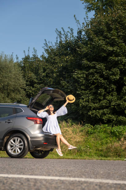 istock Woman Relaxing on SUV in Nature 2176326144