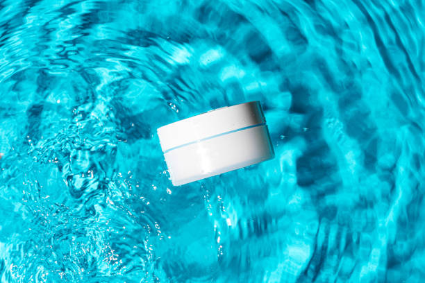 istock Sunscreen bottle floating in a clear blue swimming pool on a sunny day 2176326534
